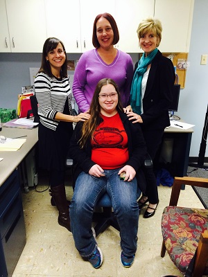 Maranda Hayes with her pair of hearing instruments donated from Oticon