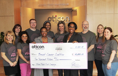 Daniell Griffin of the National Breast Cancer Coalition accepts a check for $10,000