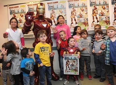 Children from New York City join Iron Man at the Center for Hearing and Communication to celebrate the debut of the Phonak Iron Man poster