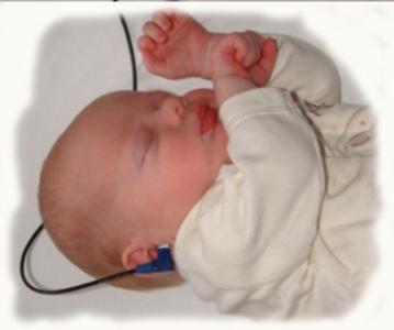 An infant has has her hearing screened