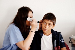 Phillips performs a visual inspection of Rublin’s ear