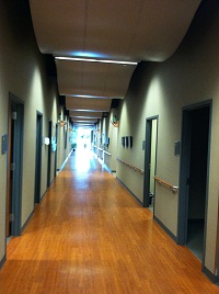 Hallway to patient suites with artwork and memorabilia hung on the walls