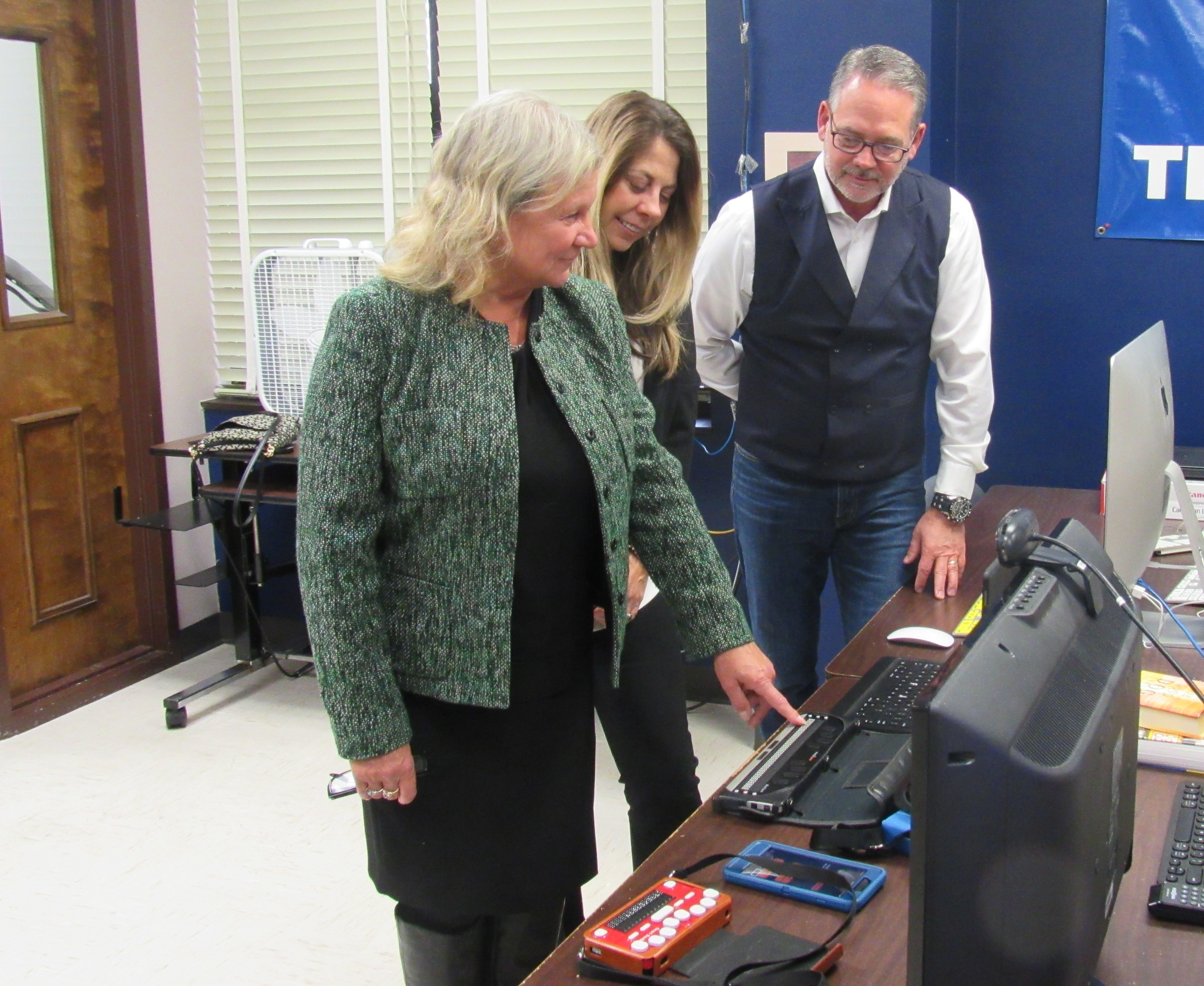 Susan Ruzenski takes Cheryl Anderson and Michael Tease on a tour of their facilities