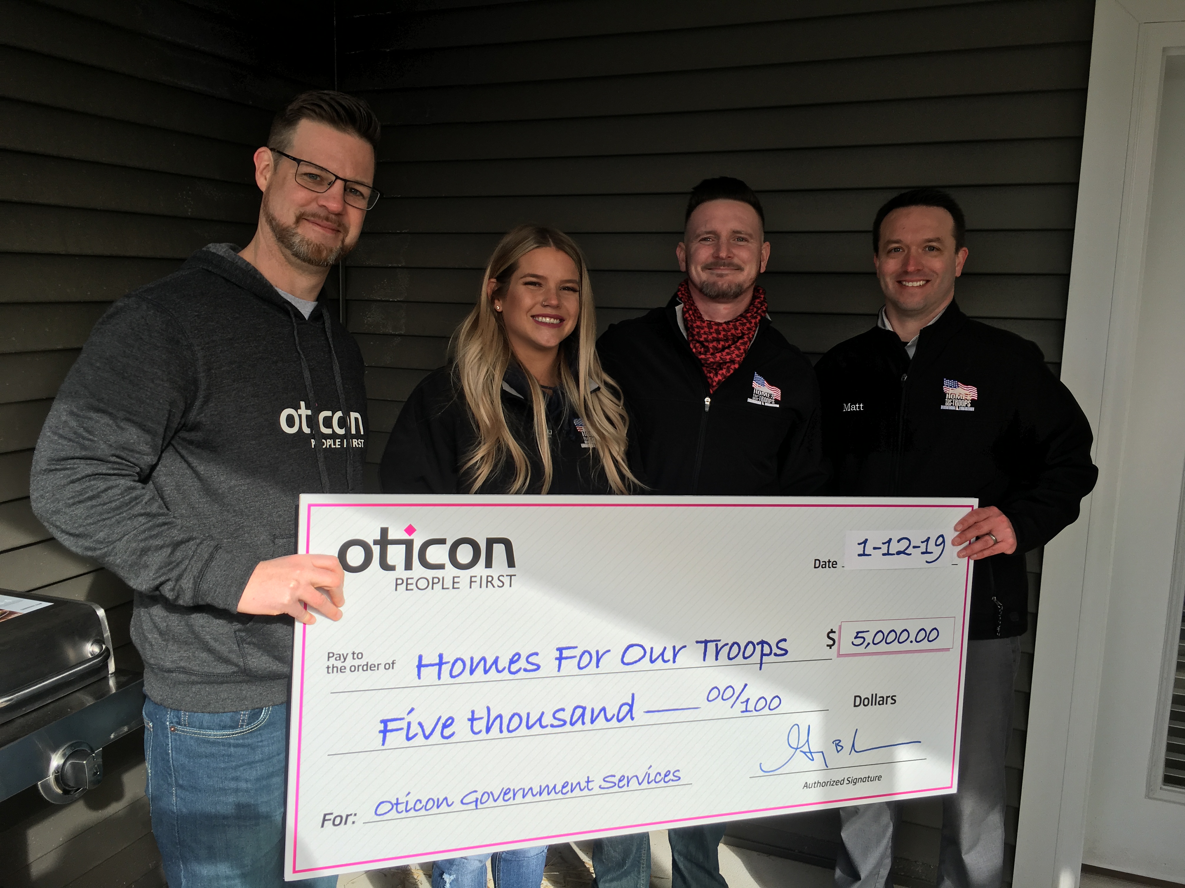 Dowd presented a $5000 check from Oticon to HFOT Manager of Corporate Philanthropy Matt McGuire to support the home build