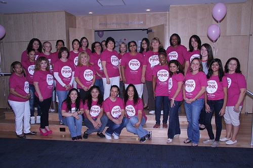 Oticon employees showing their support for breast cancer awareness