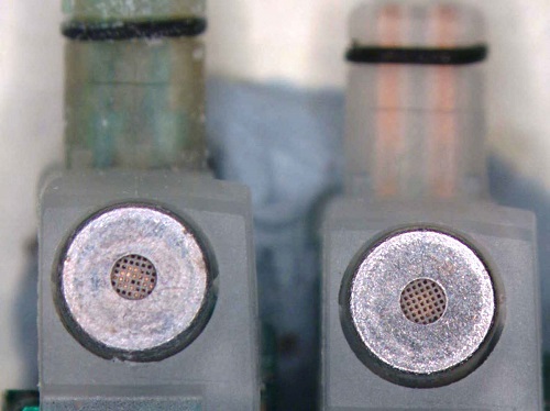 Close up view of the microphone filters of two hearing aids after undergoing the AST test