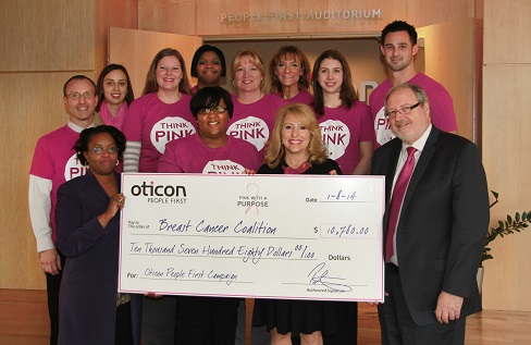 Oticon President Peer Lauritsen presents a check for $10,780 to Daniell Griffin