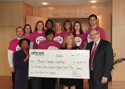 Oticon President Peer Lauritsen presents a check for $10,780 to Daniell Griffin, Director of Development at National Breast Cancer Coalition