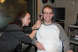 IDCD research audiologist Kelly King AuD PhD examines Chris Fortin’s hearing at the Audiology Unit at the NIH Clinical Center