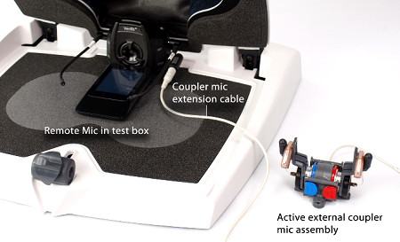 Placement of coupler mic and hearing aid assembly outside of the test box