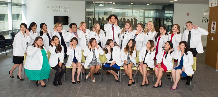 future audiologists wearing their white coats