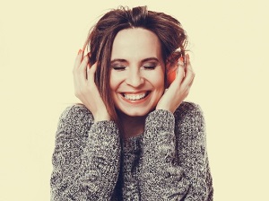 woman smiling listening to music in headphones