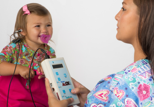 Doctor and patient with hearing screening equipment