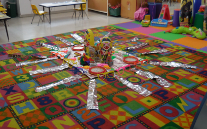 Infant classroom toys on colorful rug