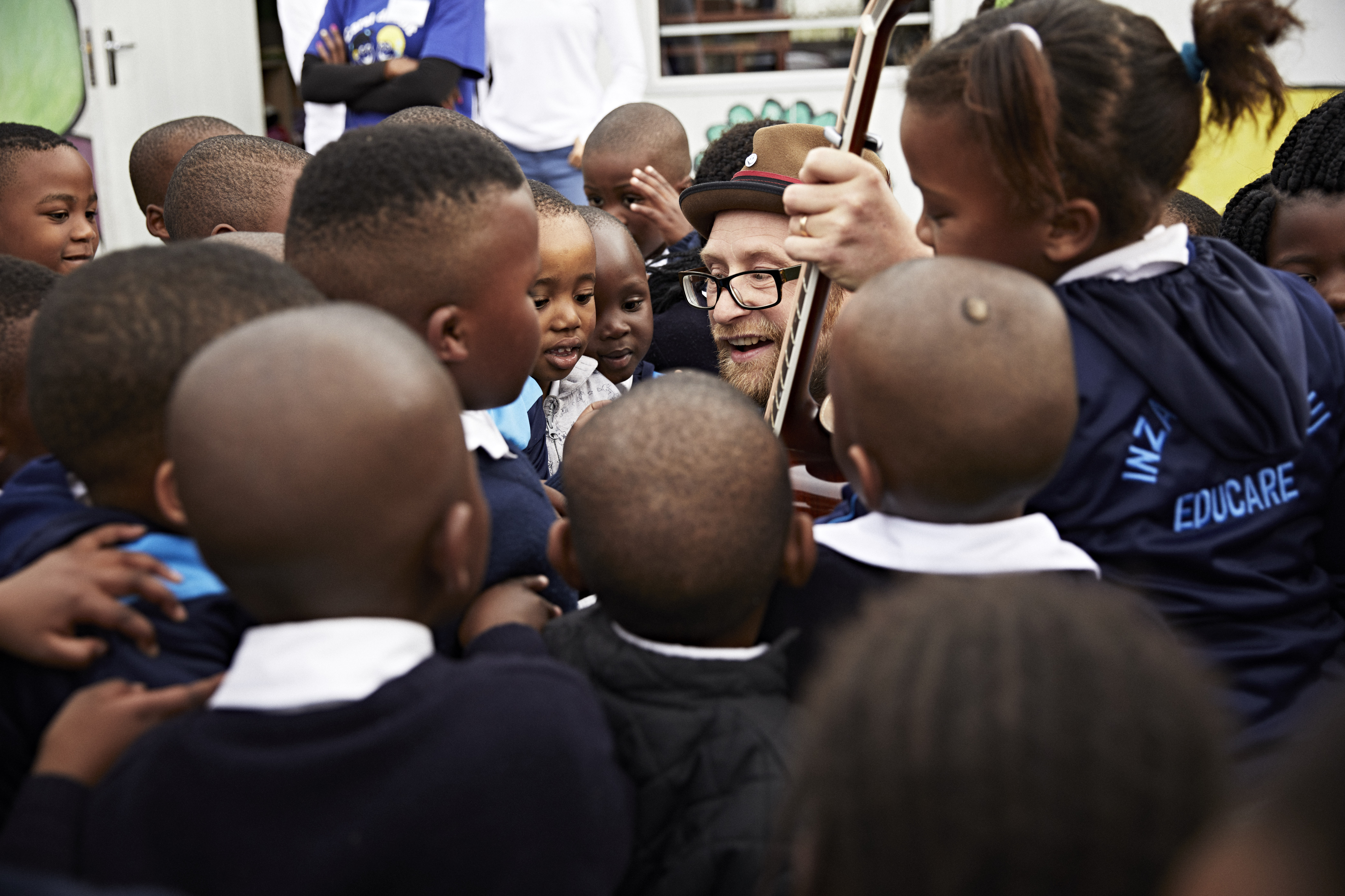 Children crowded around an adult