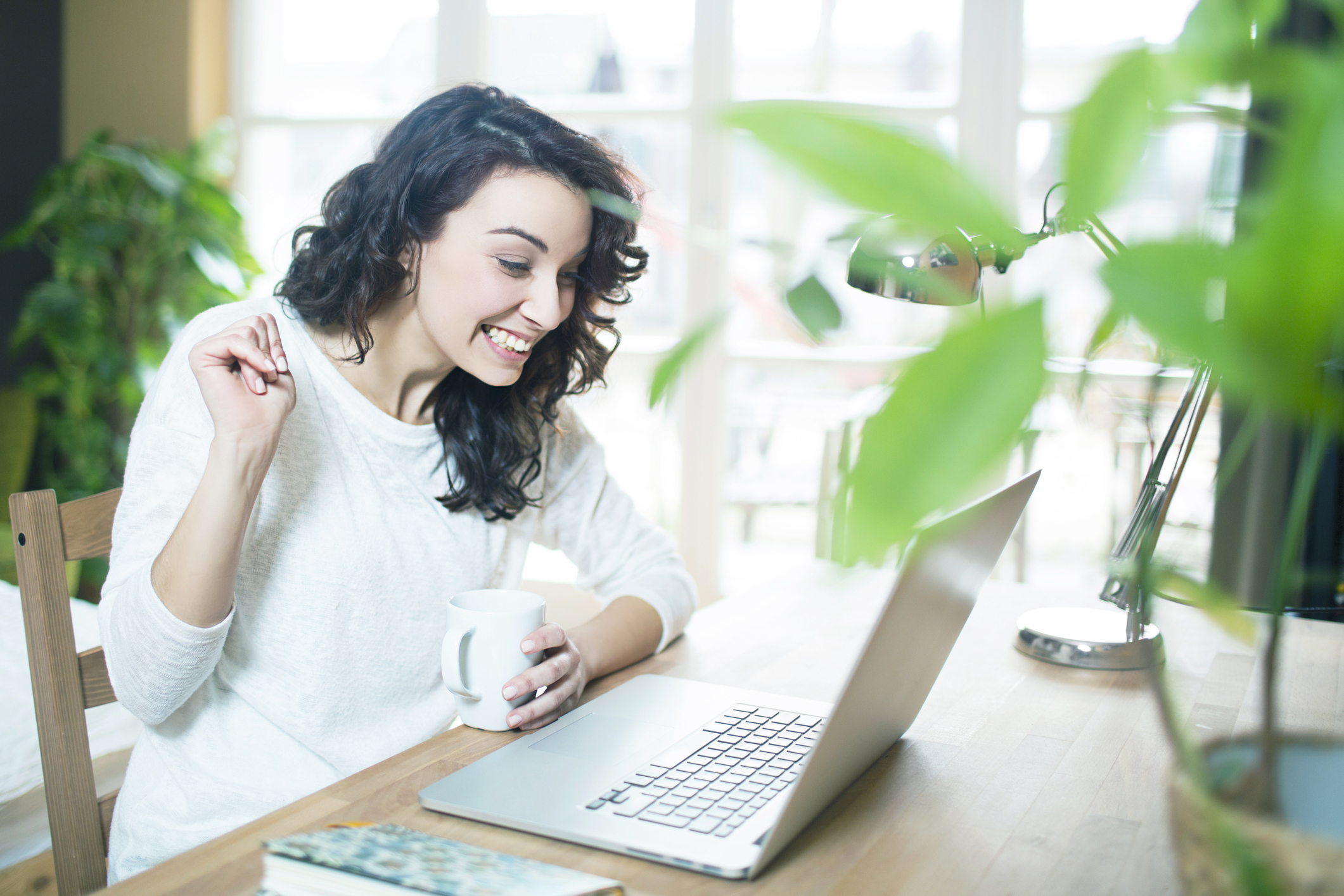 woman talking to patients via laptop