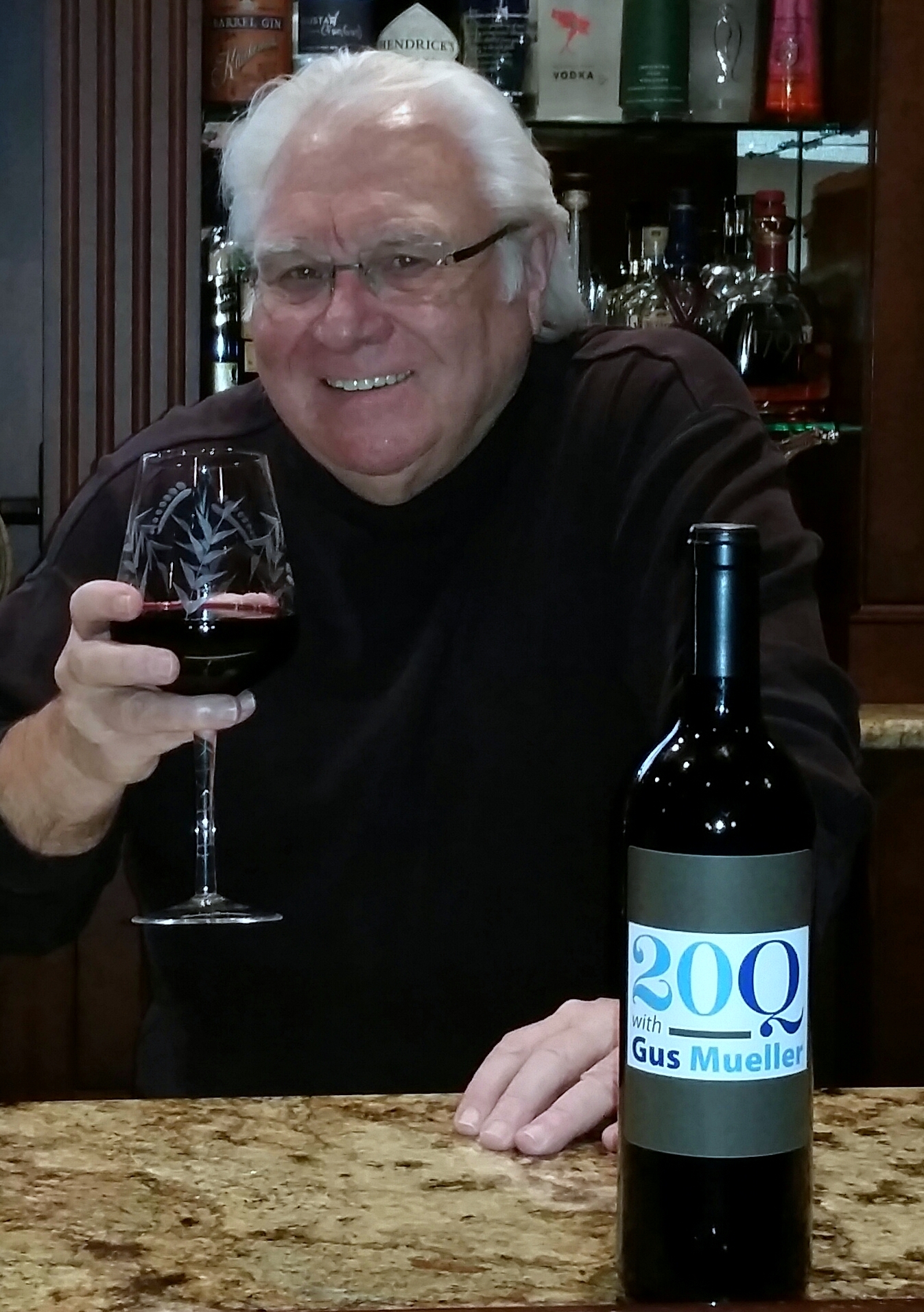 Gus Mueller toasting with a glass of red wine
