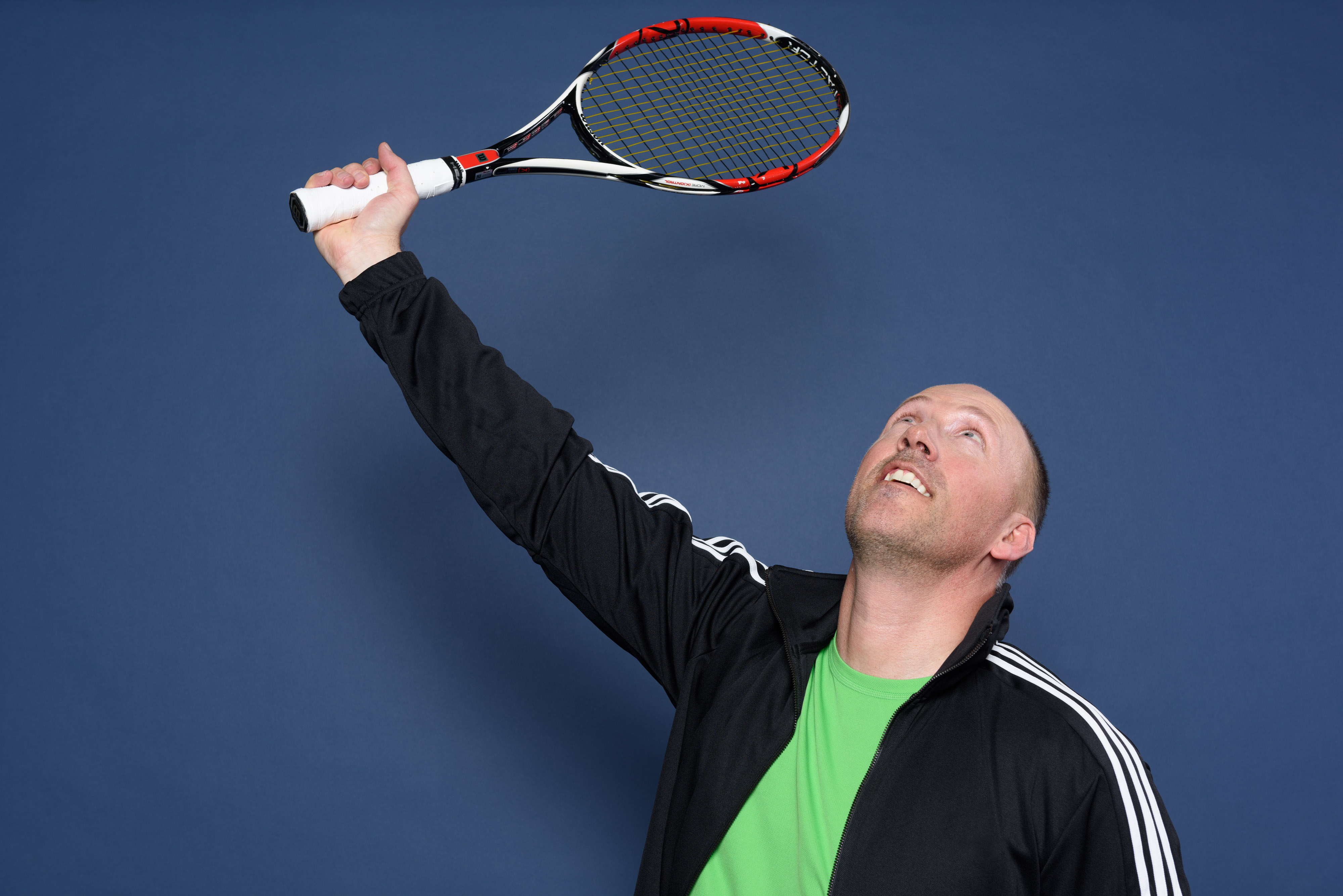 Bradley Stephenson AuD with tennis racket