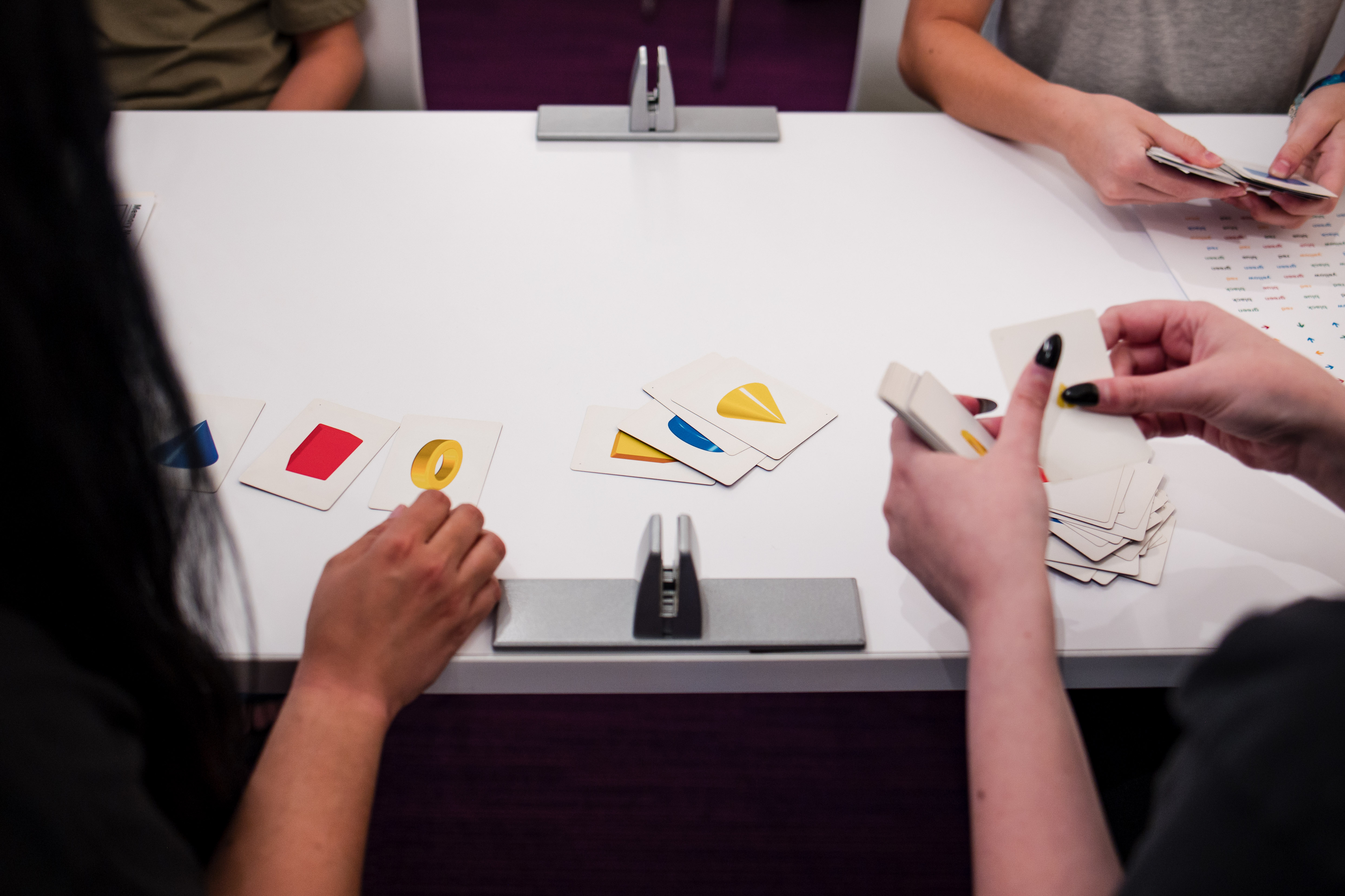 hands holding cards for an activity