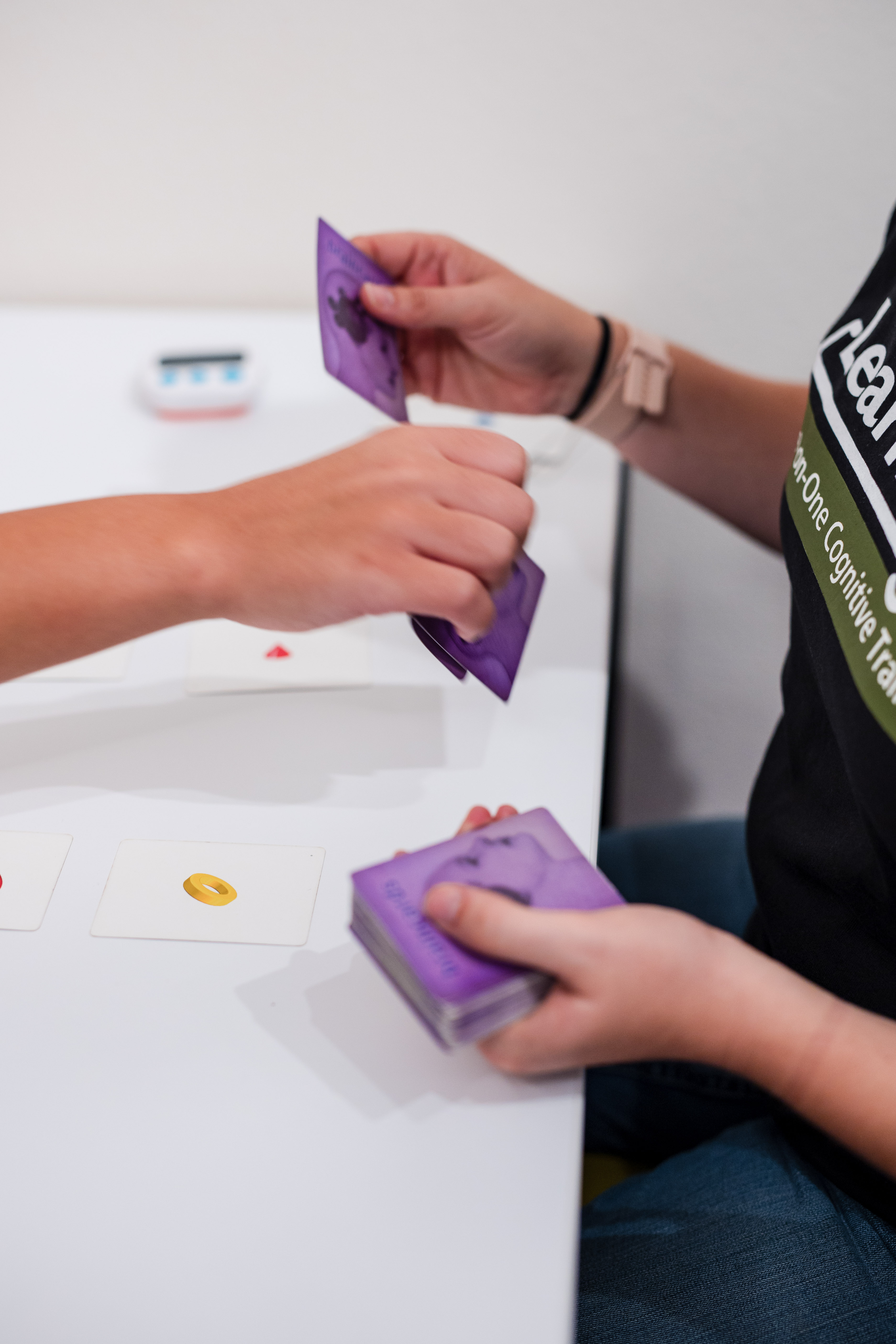 hand of team member and patient doing an activity